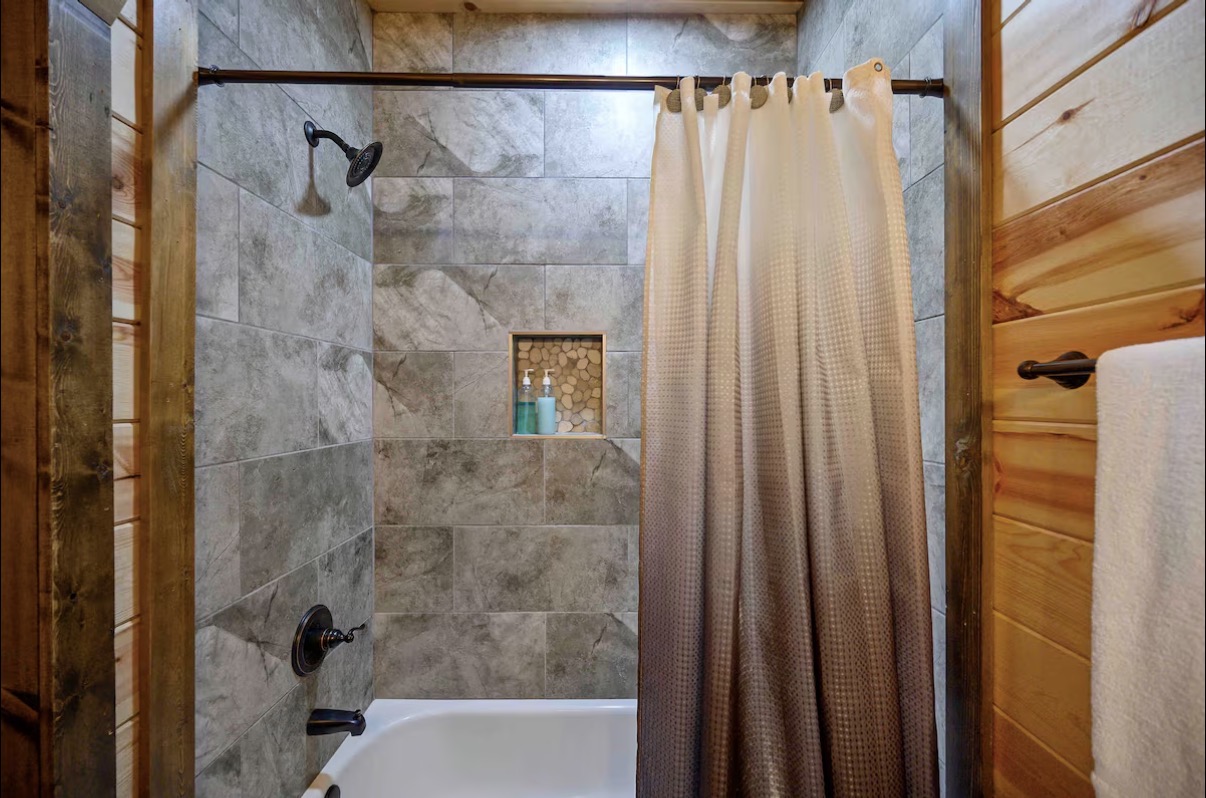 Sound of Sunshine — tiled tub-shower combo with pebble niche