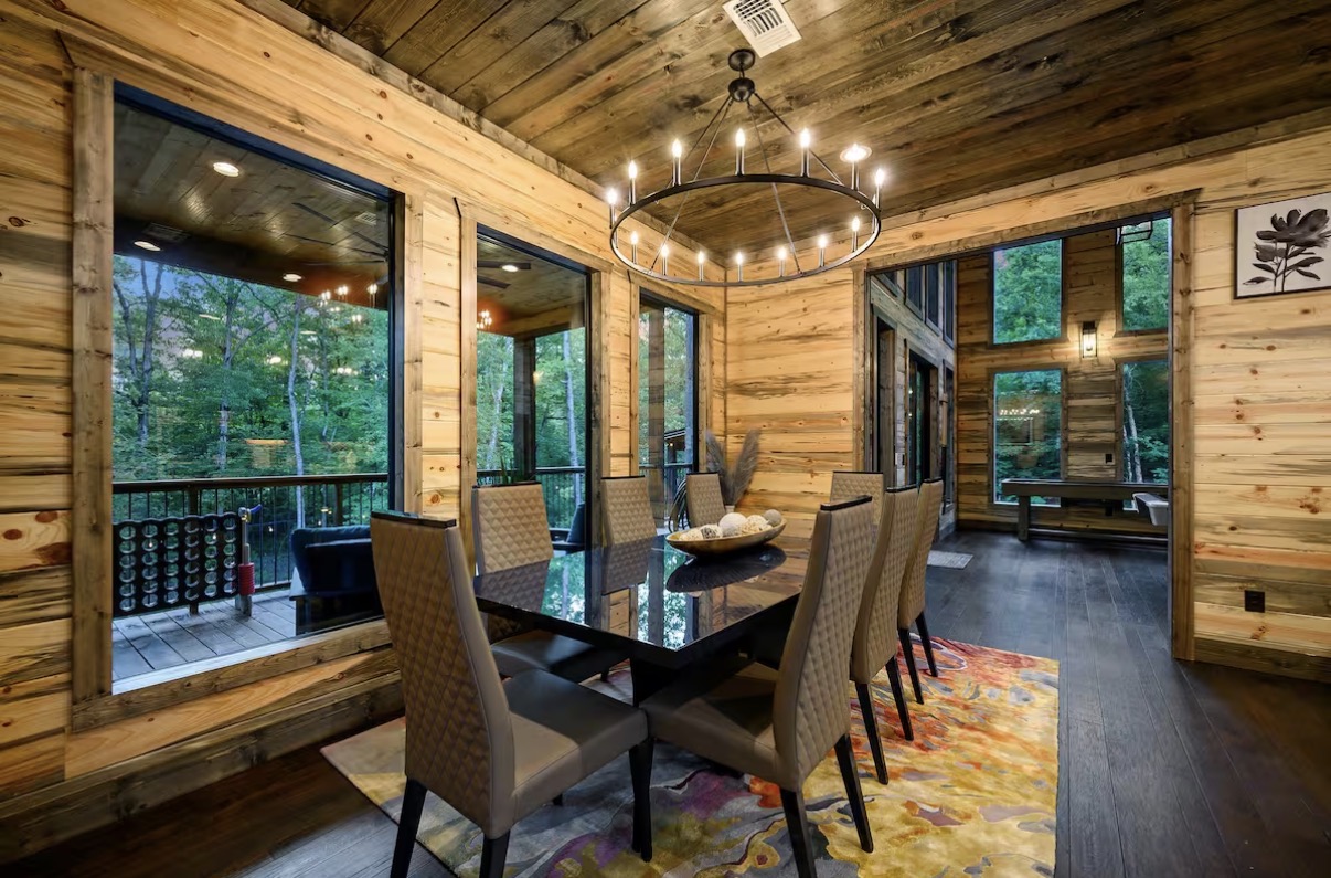 As Good As It Gets — dining room with chandelier and forest views