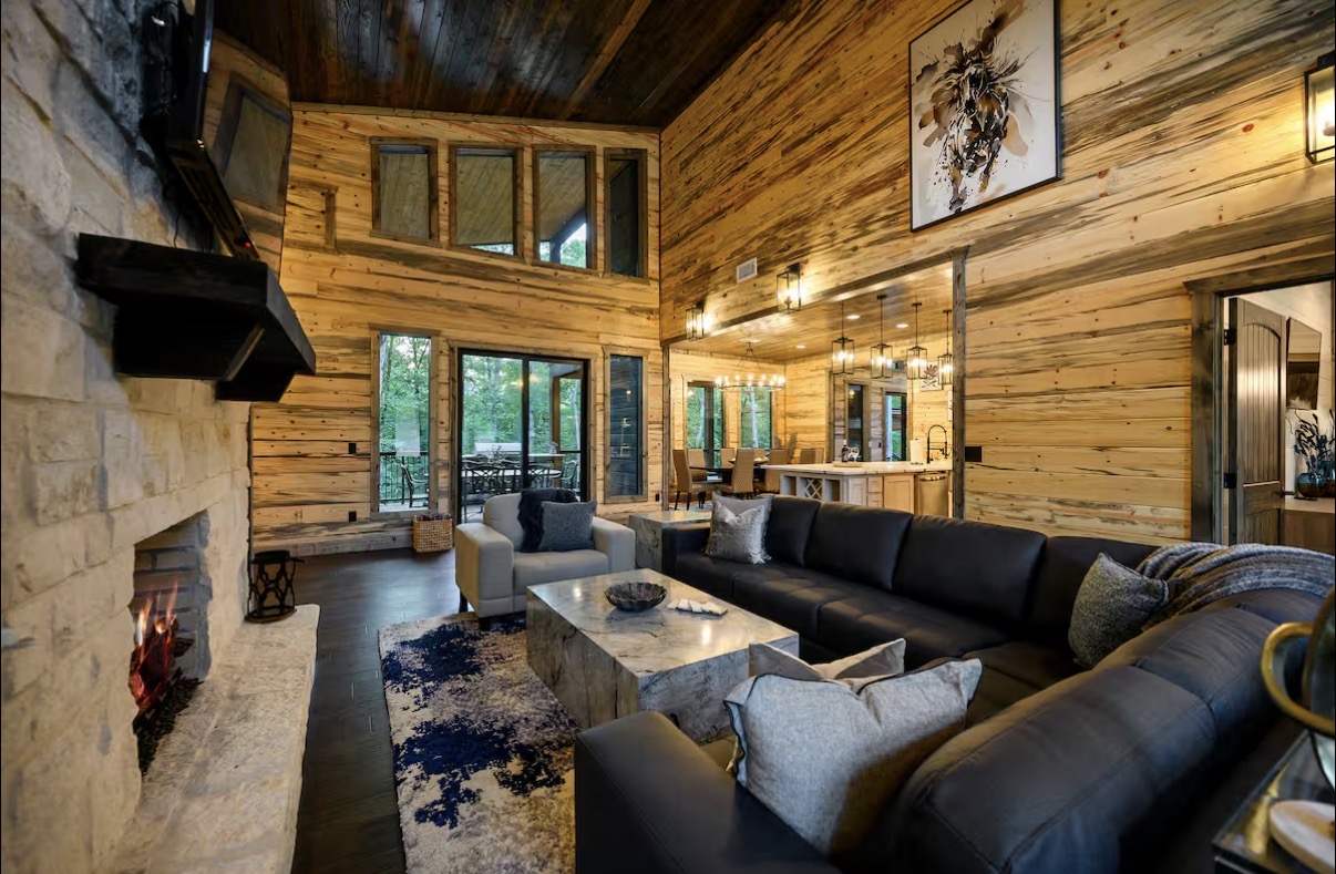 As Good As It Gets — soaring great room with stone fireplace and leather sectional