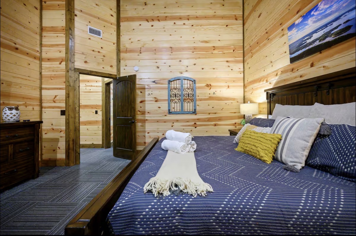 Sound of Sunshine — king bedroom side view toward doorway with coastal art