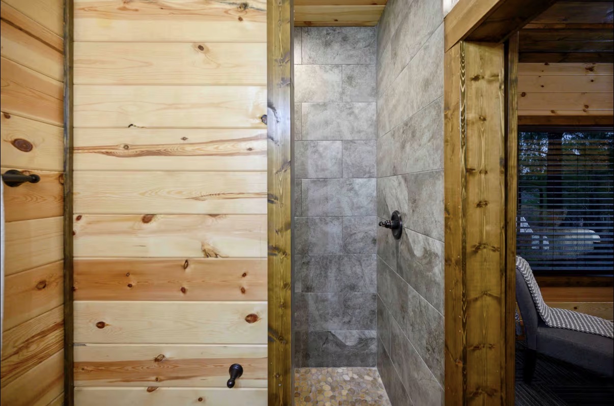 Sound of Sunshine — walk-in shower entry with slate tile and pebble floor