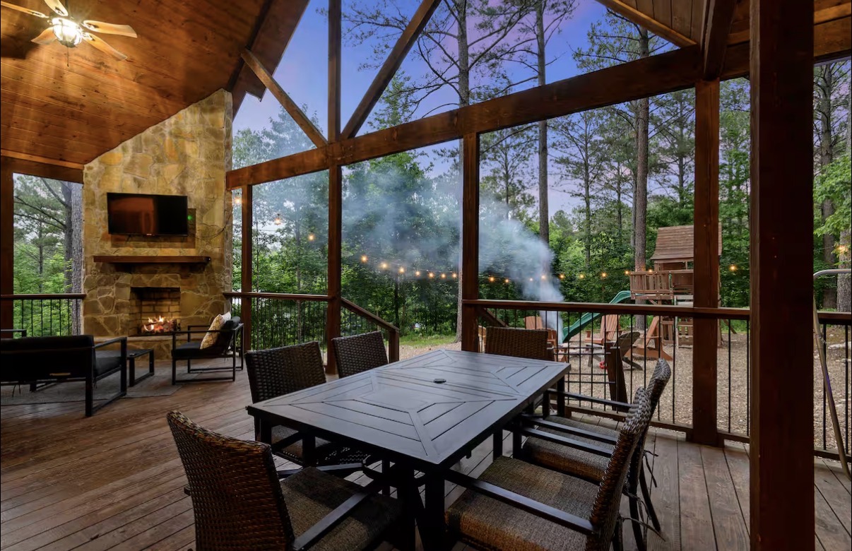 Sound of Sunshine — screened porch with stone fireplace, TV and outdoor dining