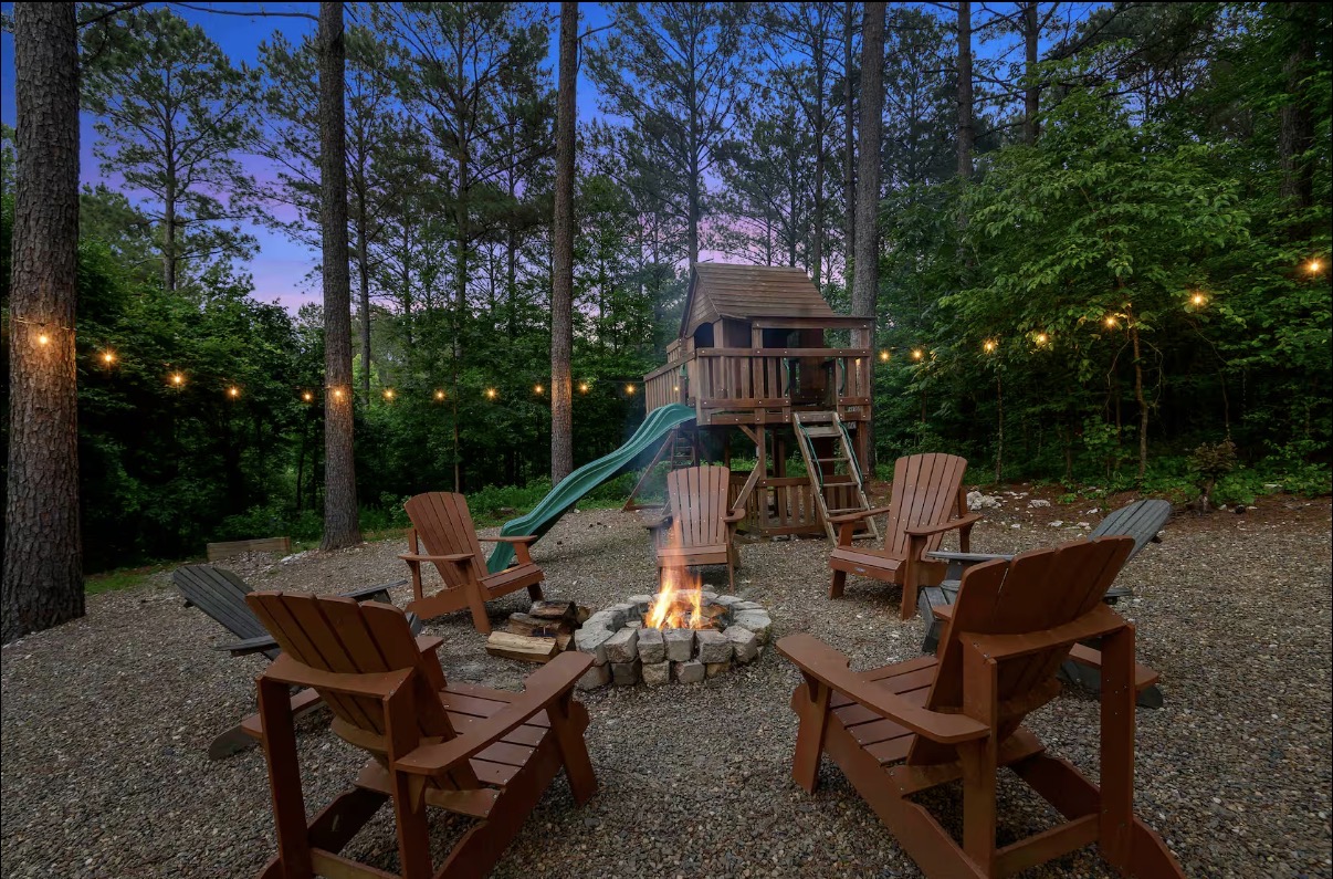 Sound of Sunshine — treehouse playset and fire pit ring at dusk