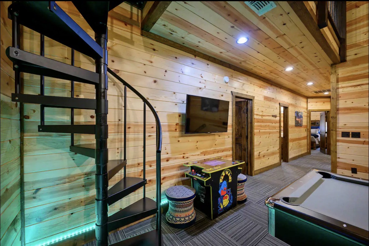 Sound of Sunshine — spiral staircase, Pac-Man arcade and mounted TV
