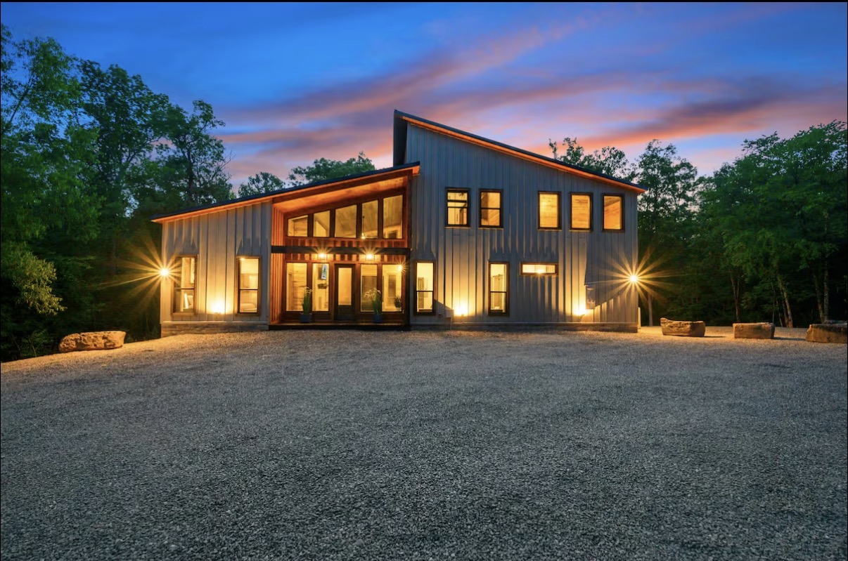 As Good As It Gets — modern exterior at dusk with warm window glow