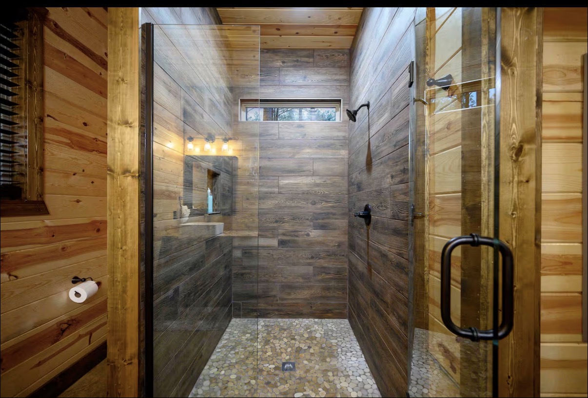 Sound of Sunshine — walk-in shower with wood-look tile and pebble floor