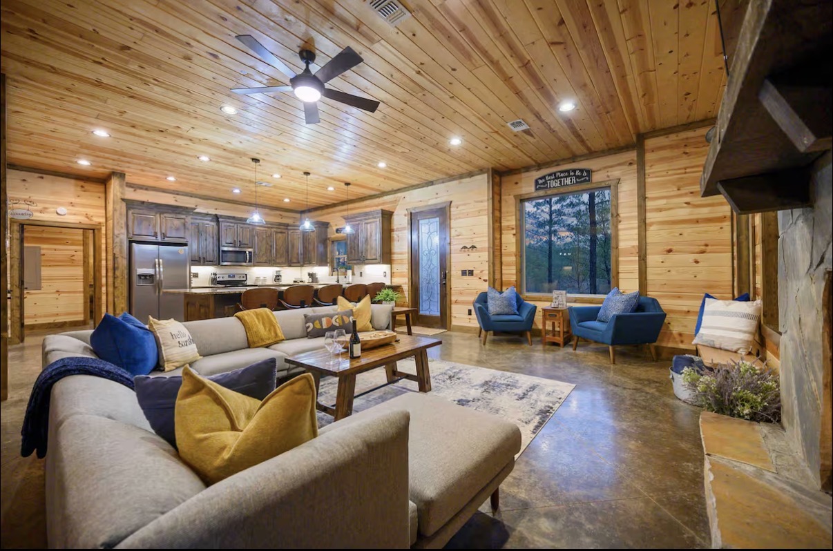 Sound of Sunshine — open great room with sectional, accent chairs and kitchen beyond