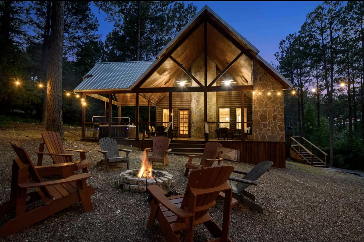 Sound of Sunshine — cabin exterior at dusk with lit fire pit and Adirondack chairs