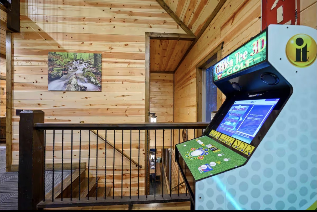 Sound of Sunshine — upstairs landing with Golden Tee arcade and waterfall canvas