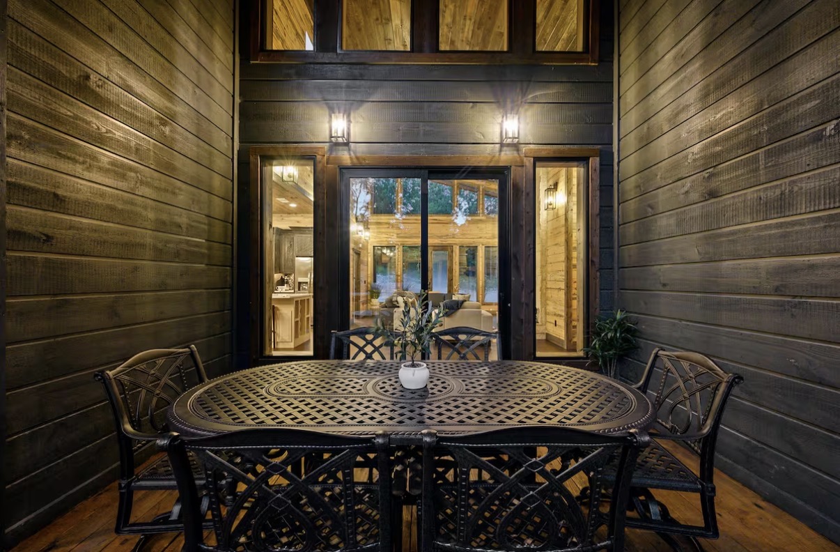 As Good As It Gets — screened porch dining table at dusk