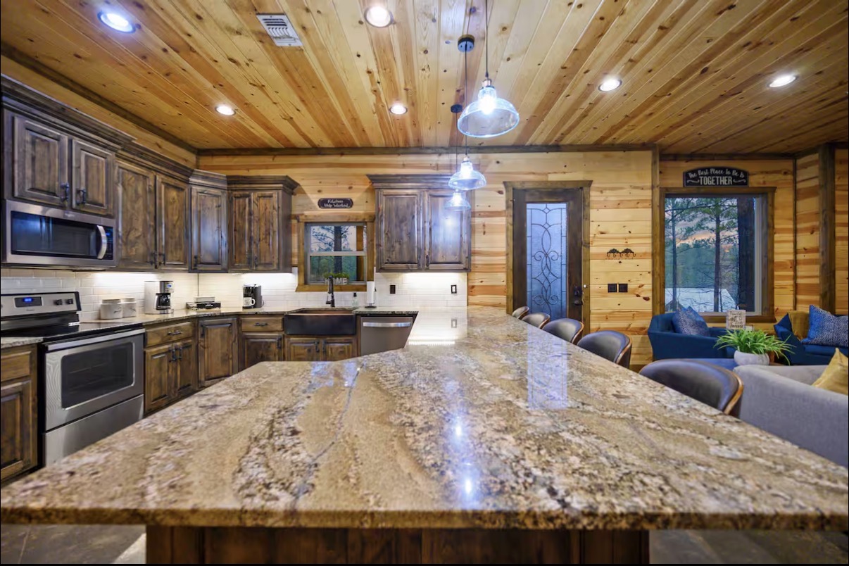 Sound of Sunshine — kitchen island with waterfall granite and pendant lighting