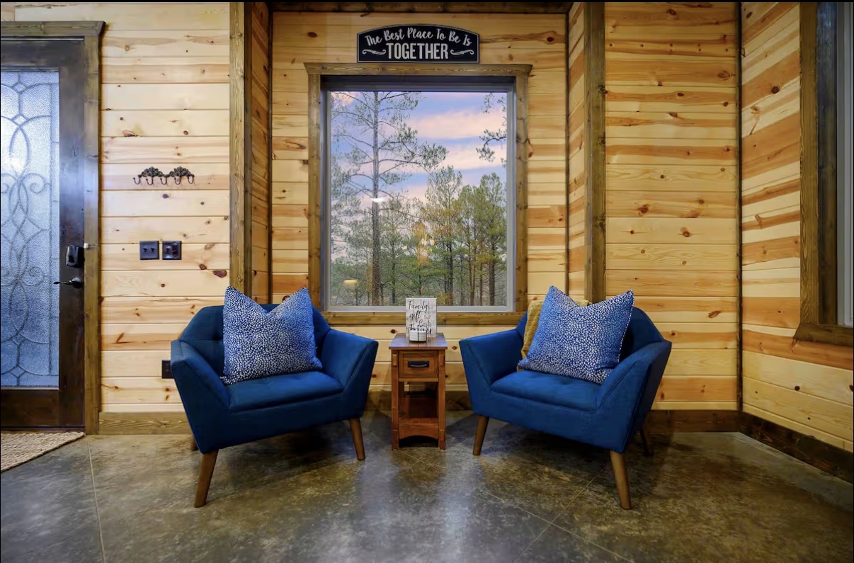 Sound of Sunshine — entry nook with blue tufted chairs beneath 'The Best Place To Be Is Together' sign