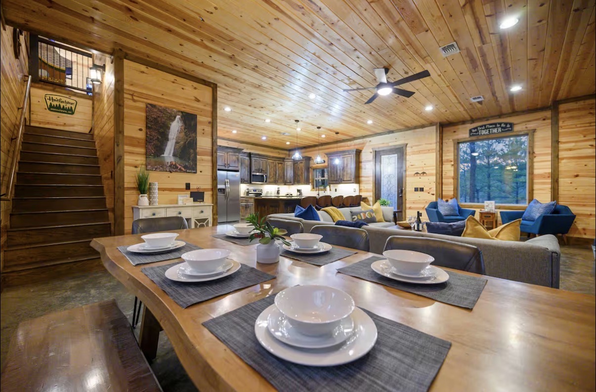 Sound of Sunshine — live-edge dining table set for six with great room beyond