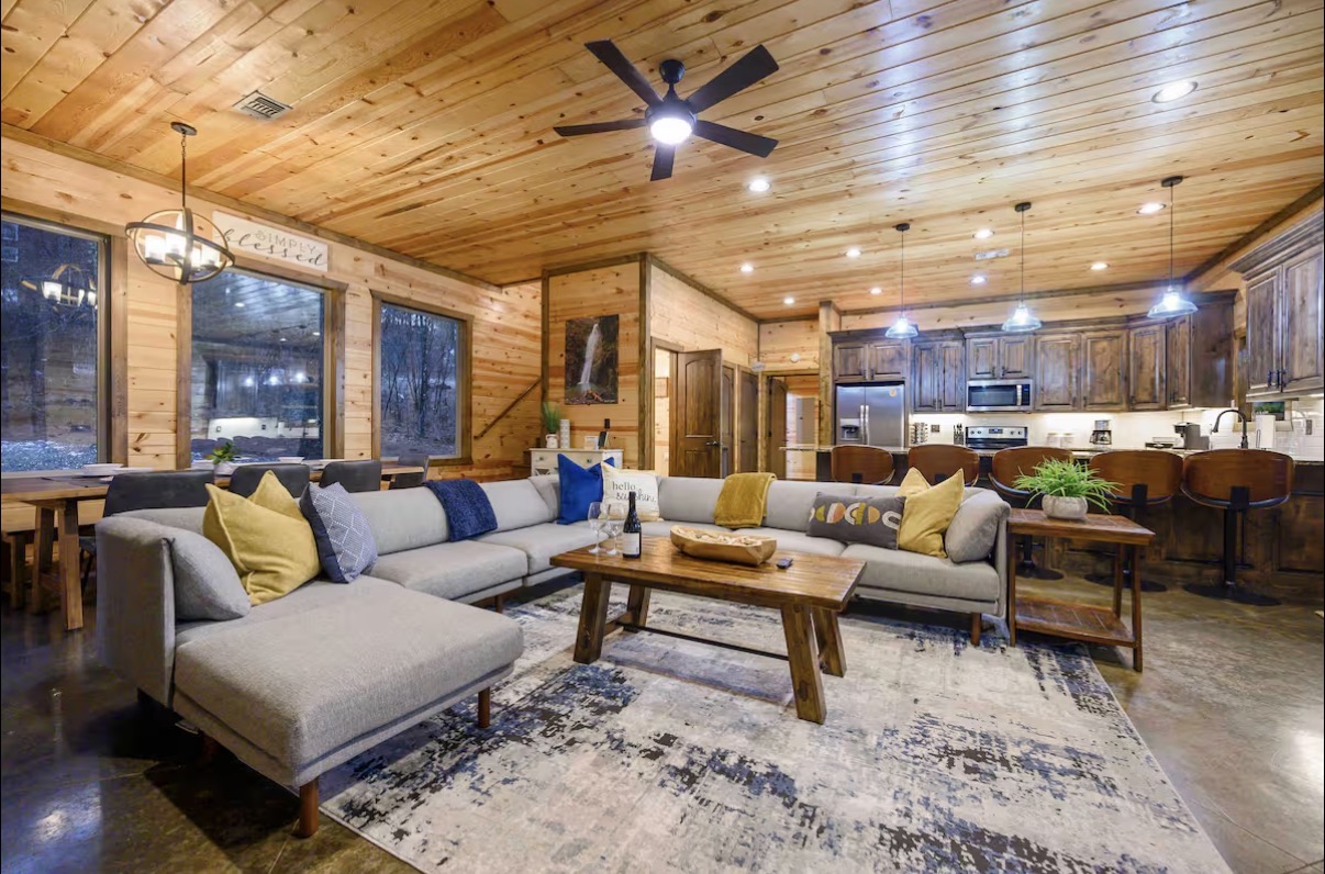 Sound of Sunshine — sectional and coffee table with dining nook and chandelier