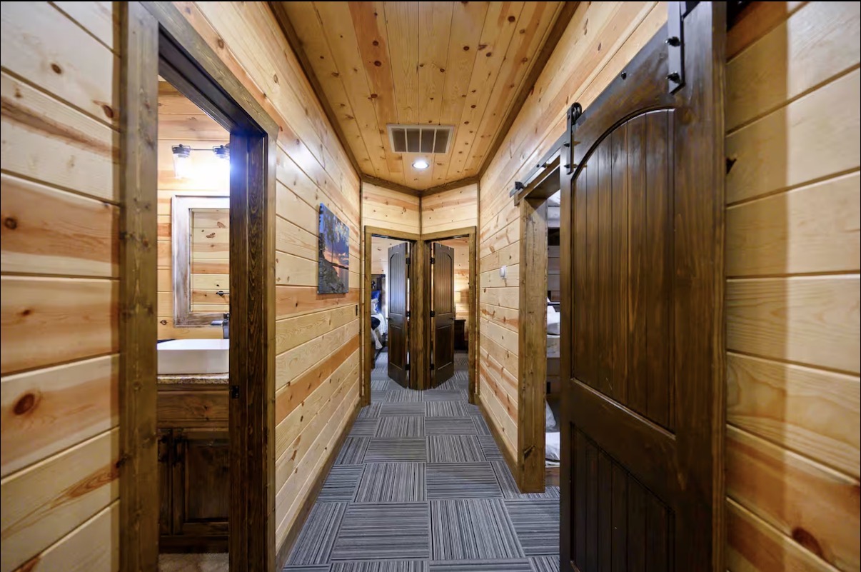 Sound of Sunshine — downstairs bedroom hallway with barn-door hardware