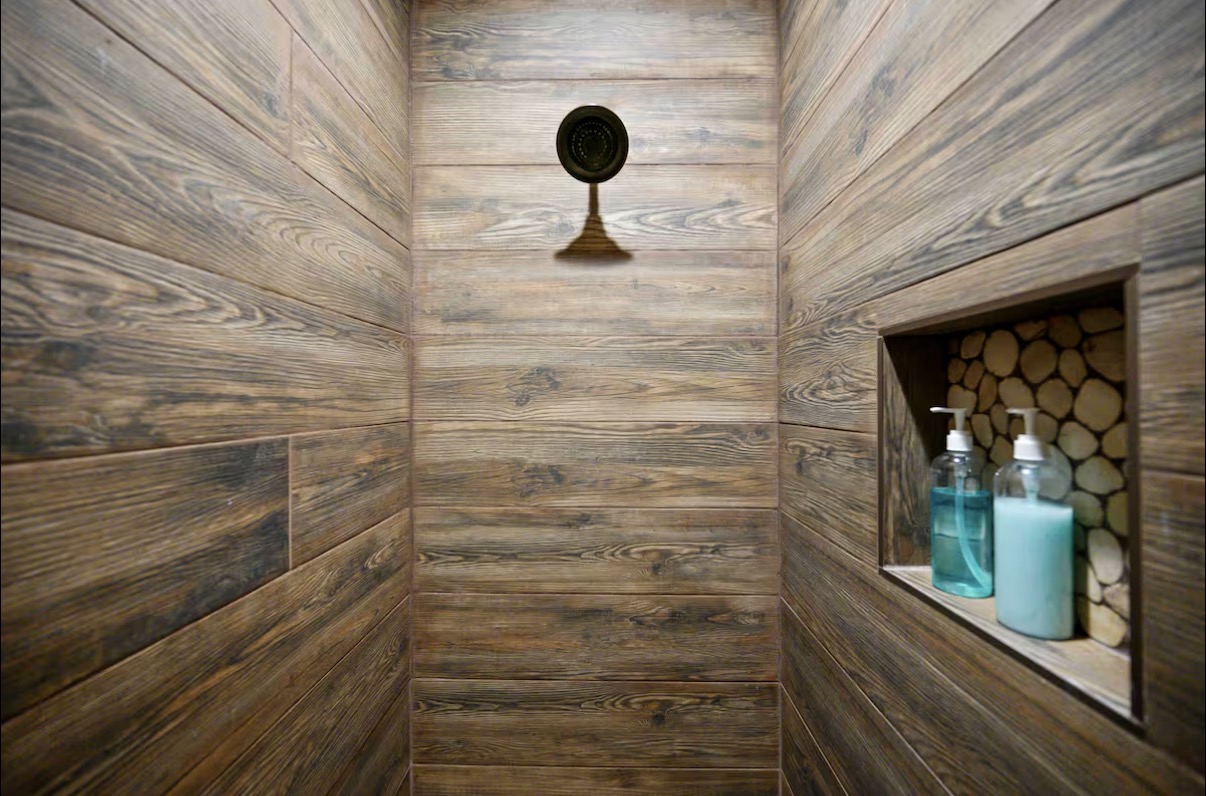Sound of Sunshine — wood-look tile walk-in shower with bronze rain head