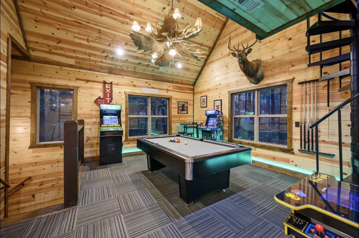 Sound of Sunshine — upstairs game room with pool table, arcades and antler chandelier