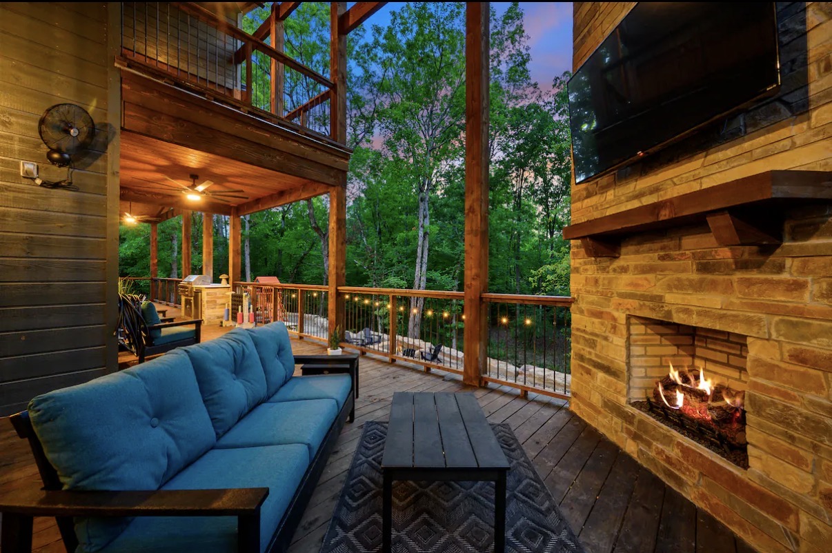 As Good As It Gets — covered deck with outdoor fireplace and TV lounge