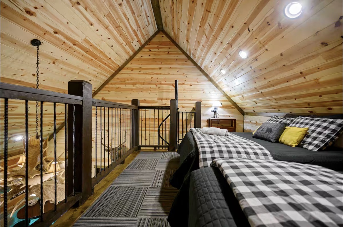 Sound of Sunshine — sleeping loft with two beds under vaulted pine ceiling