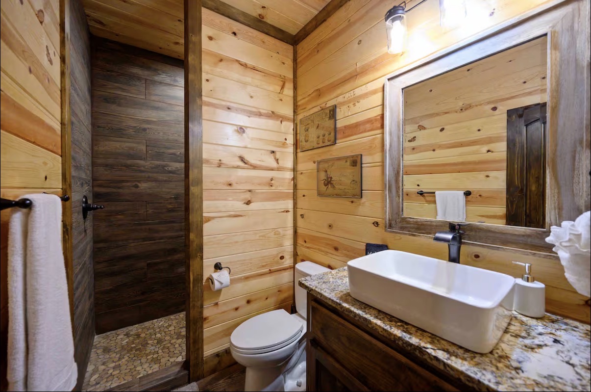 Sound of Sunshine — powder bath with wood-tile shower and granite vessel vanity