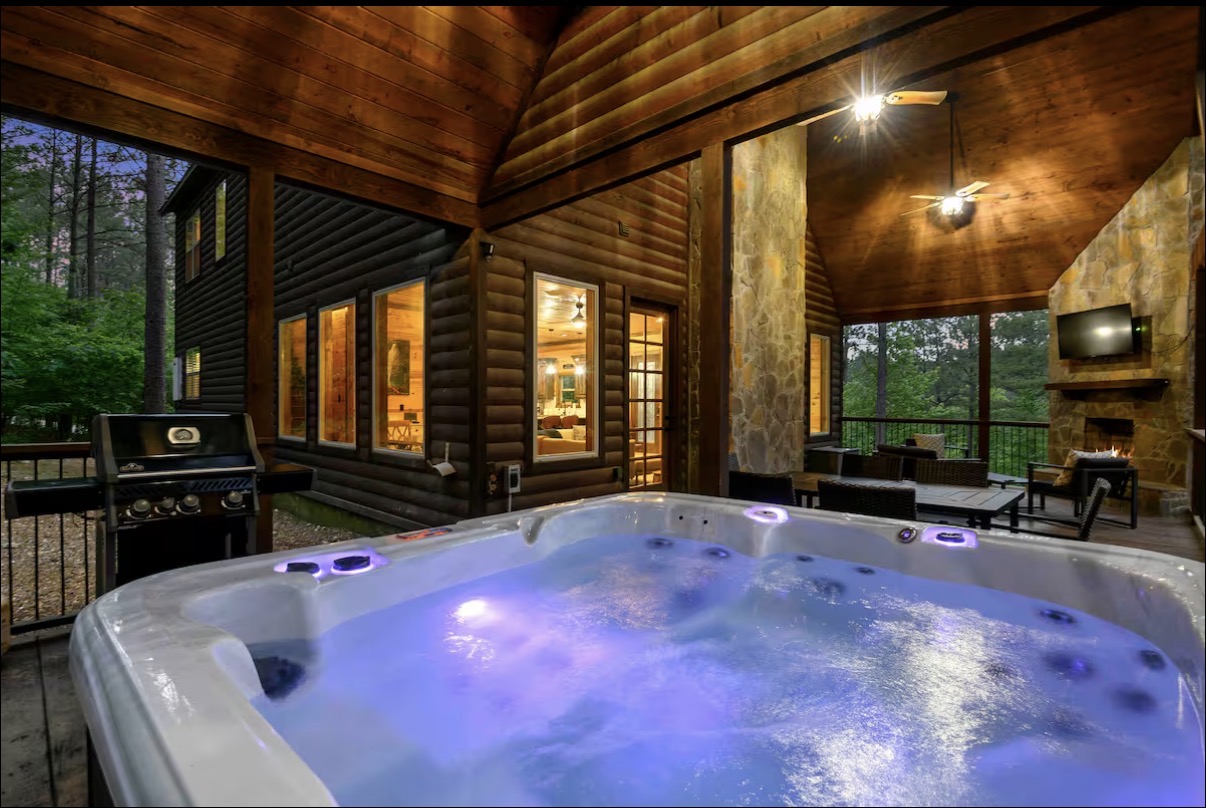 Sound of Sunshine — private hot tub with LED lighting beside grill and outdoor fireplace