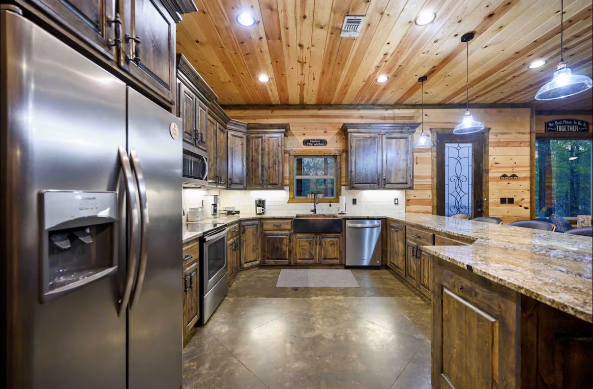 Sound of Sunshine — full kitchen view with stainless appliances and knotty alder cabinets